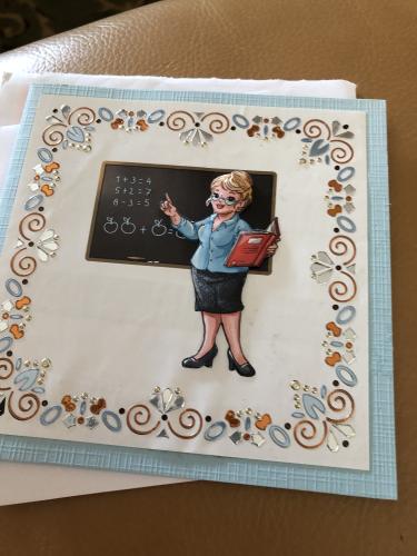 A children's drawing of the teacher on the table.