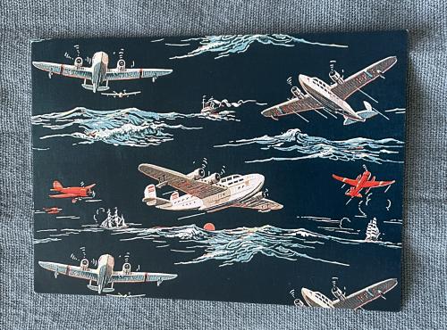 Hand drawn illustration of airplanes on the background of the blue fabric.