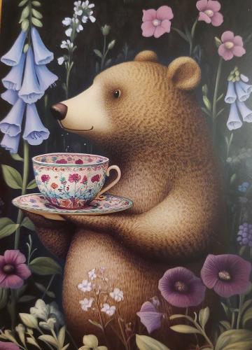 Cup of tea with bear and flowers on a dark background.