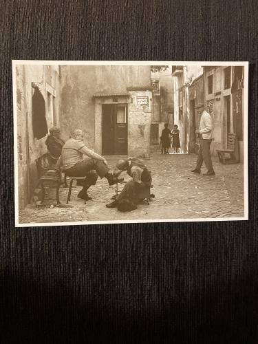 Old postcard from the mid-twentieth century with a picture of a man and a dog