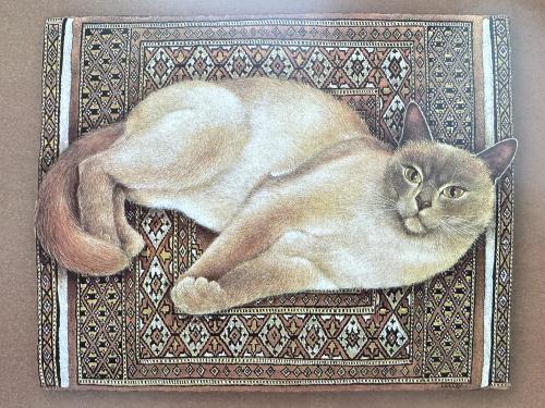 Siberian cat on a carpet. Handmade embroidery.