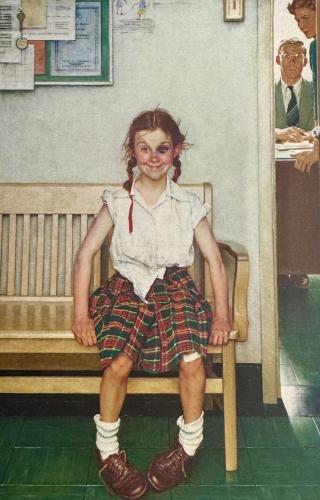 Portrait of a schoolgirl sitting on a bench in a classroom