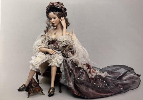 Portrait of a beautiful young girl in a medieval dress sitting on the floor
