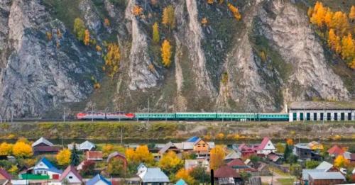 Train on the background of the autumn landscape. Russia, Krasnaya Polyana