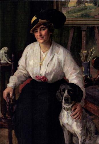 Portrait of a girl in a hat with a dog in her hand