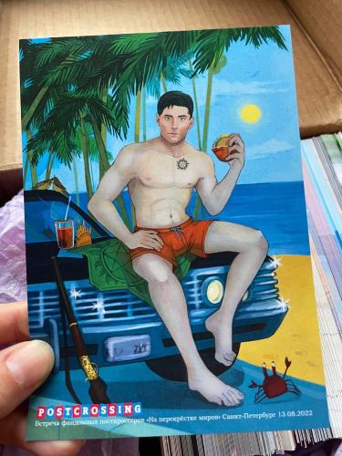 A man drinks a cocktail on the beach.