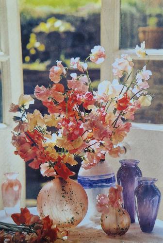 Bouquet of flowers in a vase on the windowsill Bouquet of flowers in a vase on the windowsill