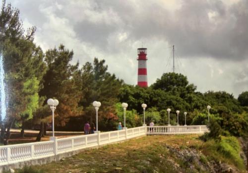 Lighthouse in the middle of the sea with white and red stripes