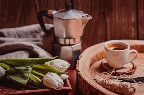 Coffee with tulips on a wooden background. Morning coffee.