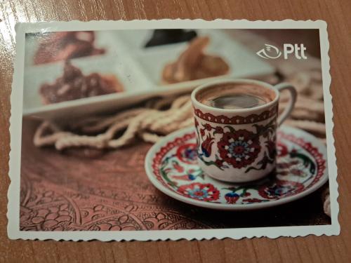Vintage cup of coffee and old photos on a wooden table.