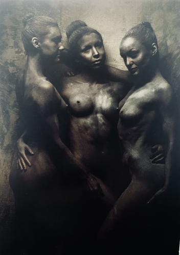 Naked women and mannequins on a wall background.