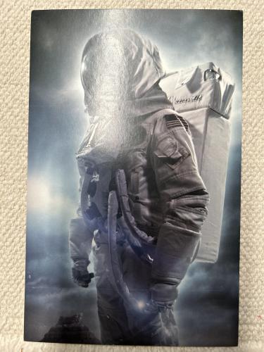 Astronaut in a spacesuit against the background of the night sky