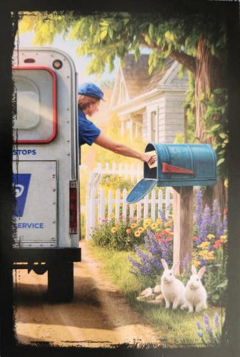 Rabbit in a mailbox in front of an old school bus.