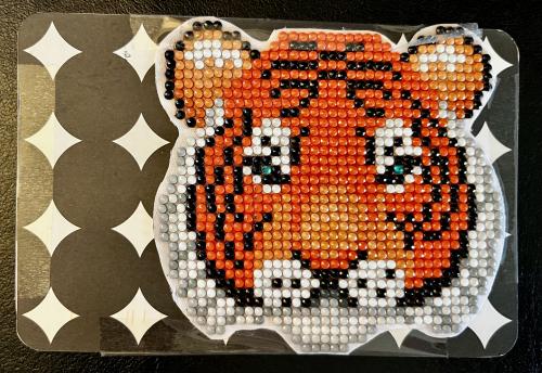 tiger made of beads on a dark background, close-up