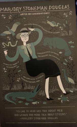 A poster with the image of a woman with a snake.