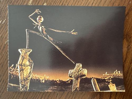 Vintage postcard with a silhouette of a witch on a broomstick