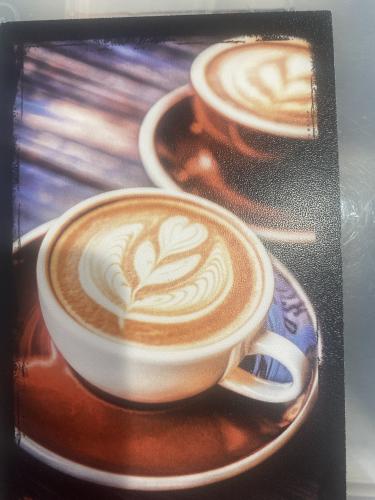 Coffee cup with latte art on table in coffee shop