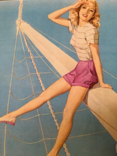 Close up of a beautiful pinup girl posing on the wall.