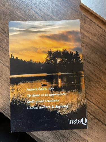 A book with the image of a sunset at the lake.